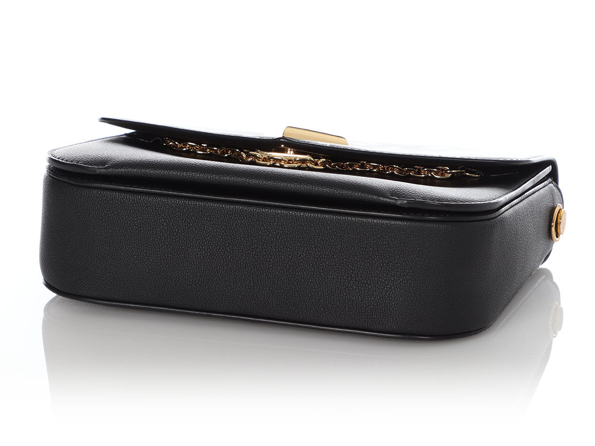 LOUIS VUITTON clutch in black grained leather with saddle