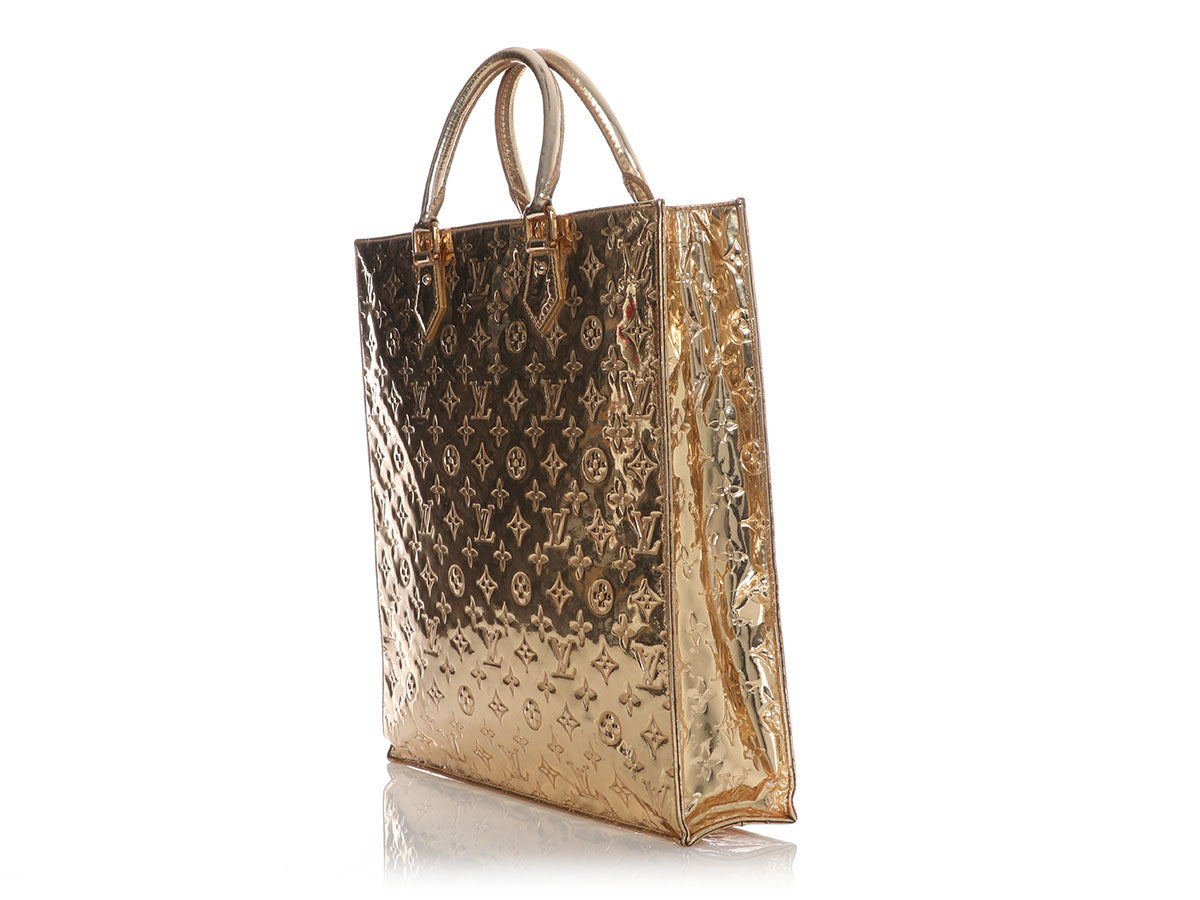 A Louis Vuitton Limited Edition Gold Monogram Miroir Sac Plat Bag, 14.25 x  15 x 4. sold at auction on 26th October