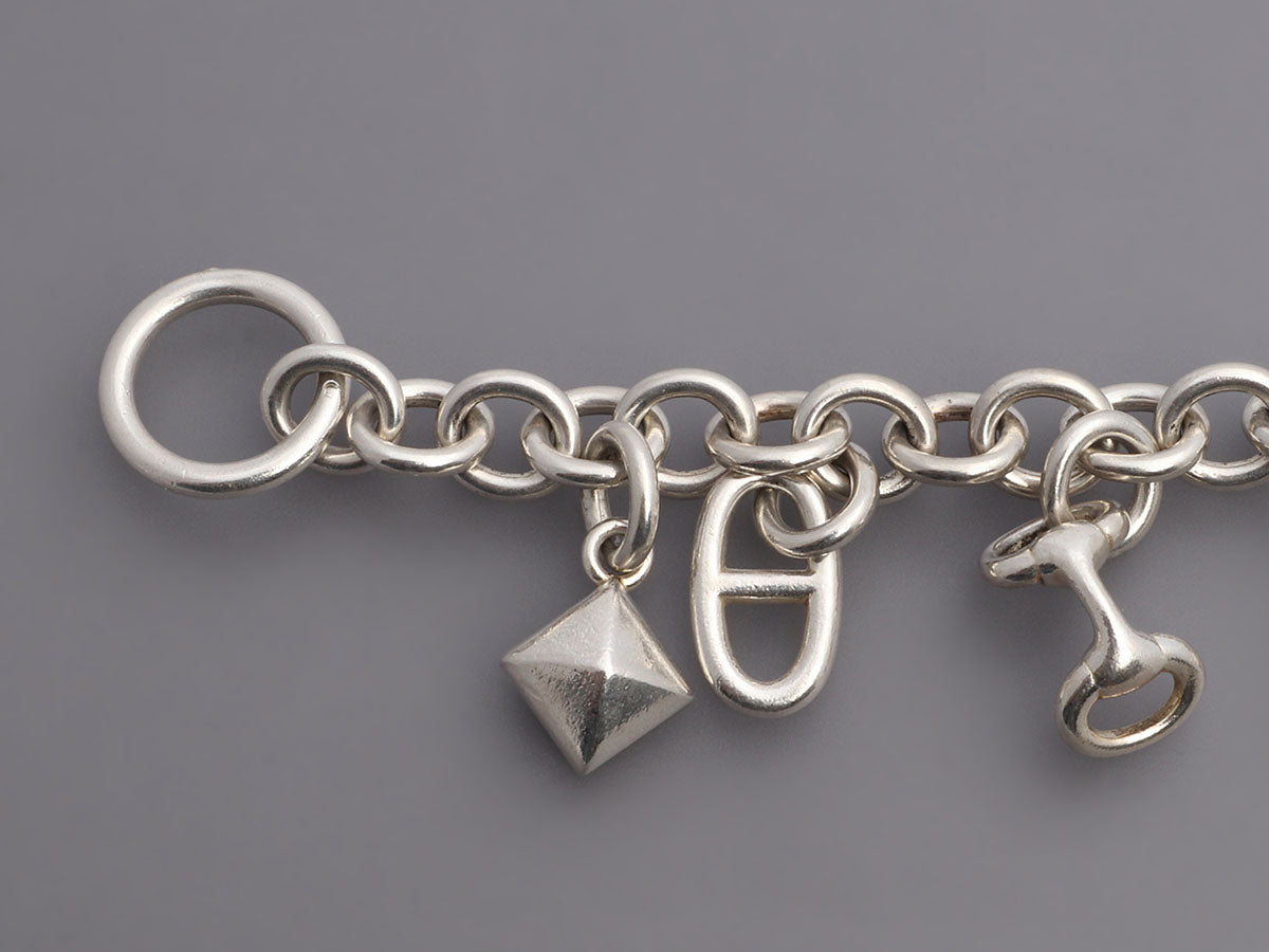 Hermes silver charm bracelet with charms that are from their iconic  collections