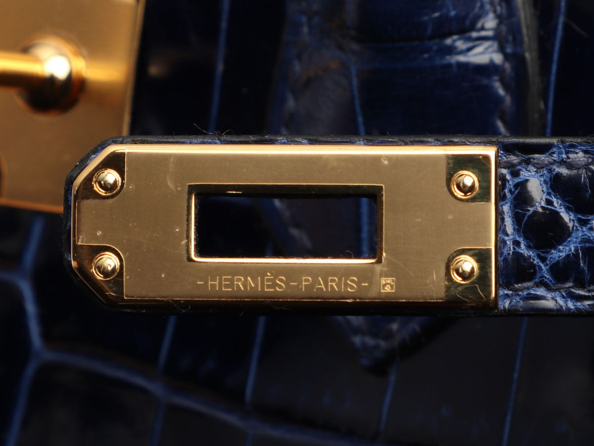 Bonhams : Hermès Blue Marine Shiny Crocodile Niloticus Birkin 25, c. 2010  (Includes padlock, keys, cloche, dust bags, rain jacket, box)